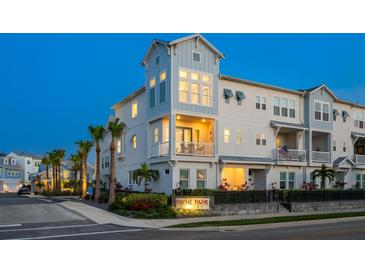 Charming townhome community with lush tropical landscaping, a well-lit sign, and a tranquil atmosphere at 405 Gowdy Rd, Sarasota, FL 34237