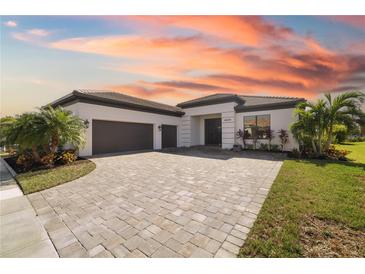 Beautiful single-story home boasts a paver driveway, lush landscaping and a three car garage at 4609 Antrim Dr, Sarasota, FL 34240
