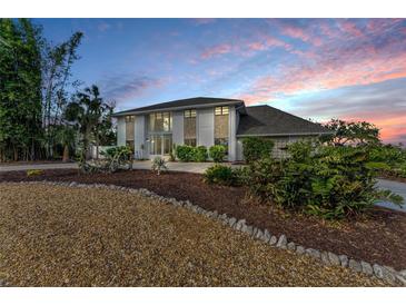 Stunning two-story home boasting large windows, stone accents, and mature landscaping in a desirable neighborhood at 7912 Desoto Memorial Hwy, Bradenton, FL 34209