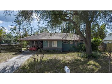 Charming single-story home with a well-maintained lawn and mature trees, offering shade and curb appeal at 2784 Martin St, Sarasota, FL 34237