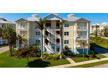 Coastal condo exterior with palm trees and white staircases at 3404 79Th Street W Cir # 301, Bradenton, FL 34209