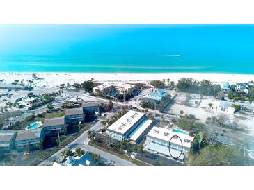 Stunning aerial view of beachfront condos, highlighting ocean views and community amenities at 4307 Gulf Dr # 208, Holmes Beach, FL 34217