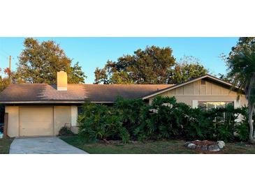 Charming single-story home with mature trees, an attached garage and a well-maintained lawn at 5032 Barcelona Ave, Sarasota, FL 34235