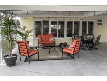 Inviting covered patio with stylish furniture, perfect for outdoor relaxation and entertaining guests at 5075 Tri Par Dr, Sarasota, FL 34234