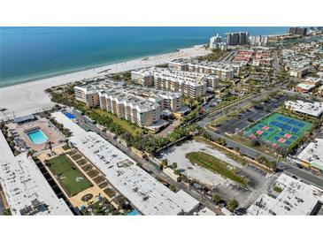 Aerial view showcasing the beachfront condo complex with tennis courts and beach access at 6500 Sunset Way # 311, St Pete Beach, FL 33706