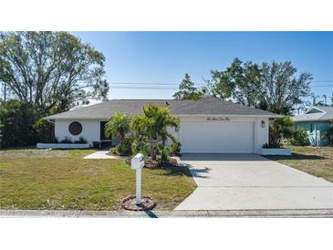 Charming single-story home with a manicured lawn, a two-car garage, and lush landscaping at 6705 20Th W Ave, Bradenton, FL 34209