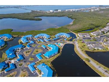 Stunning aerial view of a charming coastal community with blue rooftops and beautiful waterfront scenery at 866 Audubon Dr, Bradenton, FL 34209