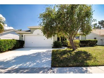 Charming single Gathering home featuring a two-car garage and a well-maintained, green lawn at 9590 Knightsbridge Cir, Sarasota, FL 34238