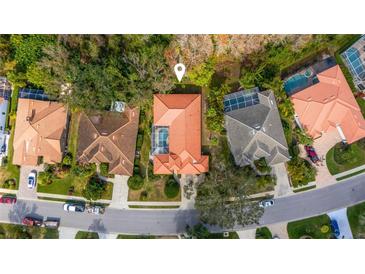 This is an aerial view of a single-Gathering home with a red tile roof and private pool at 8717 54Th E Ave, Bradenton, FL 34211