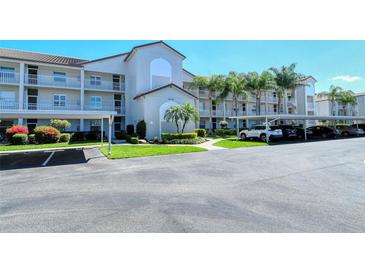Well-maintained condo complex with covered parking and tropical landscaping at 8735 Olde Hickory Ave # 8210, Sarasota, FL 34238