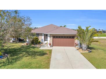 Charming one-story home with a well-manicured front yard and a neutral-colored exterior at 2080 Padre Island Dr # 211, Punta Gorda, FL 33950