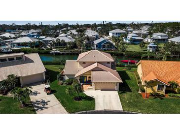 Beautiful waterfront home featuring a tile roof and mature landscaping with boat access at 27 Inlets Blvd # 27, Nokomis, FL 34275