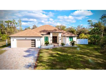 Beautiful single-story home featuring a well-manicured lawn and a stylish three-car garage at 4396 Everglades Ter, North Port, FL 34286