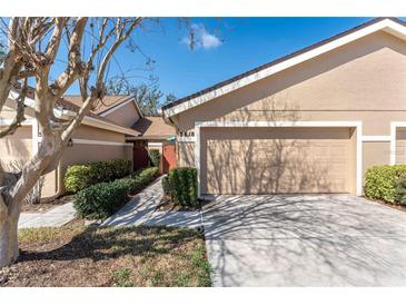 Charming home showcasing a well-maintained front yard and a two-car garage with a neatly manicured walkway at 5618 Monte Rosso Rd, Sarasota, FL 34243