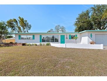 Charming single-story home with a well-maintained front yard and bright turquoise trim at 5724 25Th W St, Bradenton, FL 34207