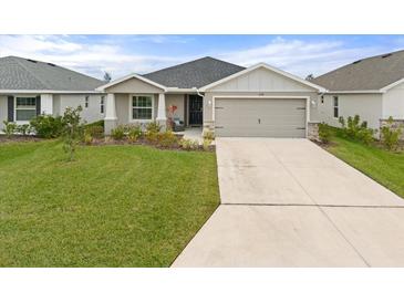 Charming single-story home with a well-manicured lawn and a two-car garage and neutral color scheme at 6708 162Nd E Pl, Parrish, FL 34219