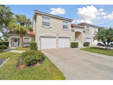 Two-story townhouse with dual garage, red tile roof, and well-maintained landscaping at 7232 Cedar Hollow Cir # 7232, Bradenton, FL 34203