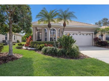 Charming home showcasing manicured lawn and vibrant landscaping, creating a welcoming curb appeal at 7608 Teal Trce, Bradenton, FL 34203