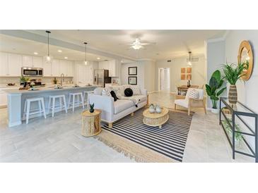 Open living area with a large island kitchen, dining space, modern decor, and a relaxing atmosphere at 12510 Ghiberti Cir # 102, Venice, FL 34293