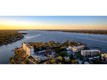 Breathtaking aerial view of waterfront property, showcasing its prime location and stunning sunset backdrop at 1609 1St W Ave, Bradenton, FL 34205