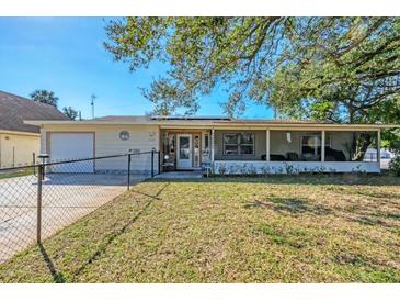 Charming single-story home with a large screened in porch and fenced front yard at 2202 21St W St, Bradenton, FL 34205