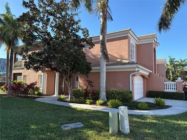 Charming two-story home featuring a well-maintained lawn, lush landscaping, and a two-car garage at 5462 46Th W Ct, Bradenton, FL 34210