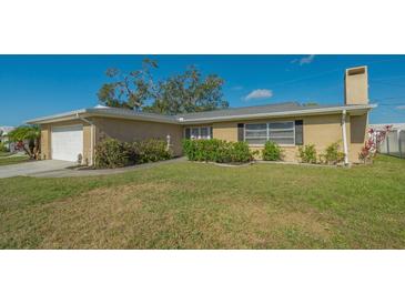 Charming single-story home featuring neat landscaping and mature shrubbery at 6716 Keystone Dr, Sarasota, FL 34231