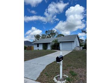 Charming single-story home with a well-manicured front yard and an attached one-car garage at 7109 Java Dr, Sarasota, FL 34241