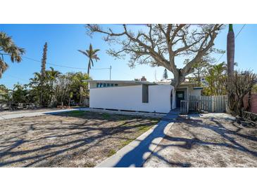 Modern exterior with unique architecture and mature trees offering shade and character to the property at 132 Harrison Dr, Sarasota, FL 34236
