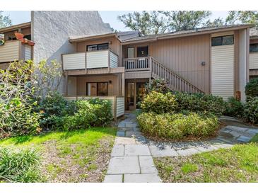 Inviting two-story townhome featuring a private entrance and lush landscaping at 1680 Brookhouse Cir # 110, Sarasota, FL 34231