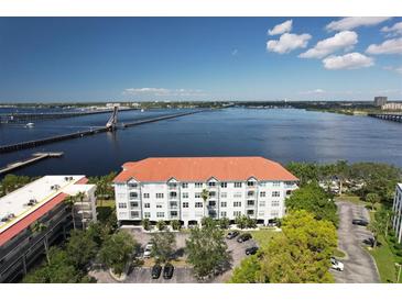 Stunning waterfront condo building boasts a red tile roof and serene views of the bay at 210 3Rd W St # 8204, Bradenton, FL 34205