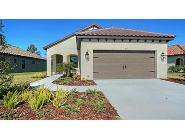 Charming single-story home with a tile roof, stucco exterior, and a well-manicured lawn at 217 Potenza Loop, North Venice, FL 34275