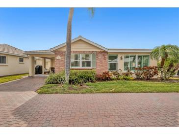 Charming single-story home featuring brick accents, lush landscaping, and a brick-paved driveway at 6140 Midnight Pass Rd # B6, Sarasota, FL 34242