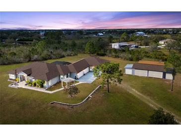 Expansive property featuring a custom home, detached garage, lush landscaping and plenty of room to roam at 25605 69Th E Ave, Myakka City, FL 34251