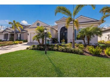 Inviting home with a well-kept lawn, lovely landscaping, and a convenient two-car garage at 3605 Wild Blossom Pl, Parrish, FL 34219