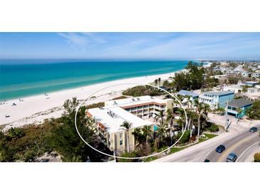 Beautiful aerial view of a condo building with a sandy beach and ocean in the background at 4200 Gulf Dr # 101, Holmes Beach, FL 34217