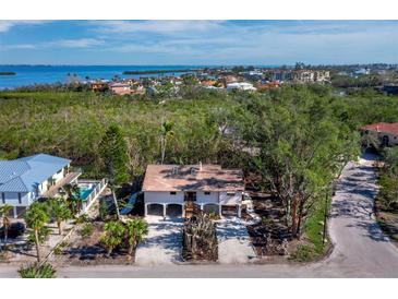 Inviting exterior elevation of home near the water and lush greenery at 650 Penfield St, Longboat Key, FL 34228