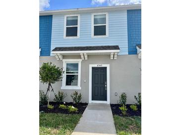 Charming two-story townhome with well-maintained landscaping and welcoming front entrance at 8949 Daybreak St, Sarasota, FL 34241