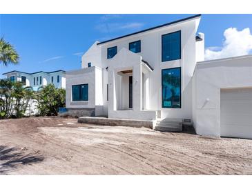 Modern two-story home featuring a clean white facade and large windows at 927 Contento St, Sarasota, FL 34242