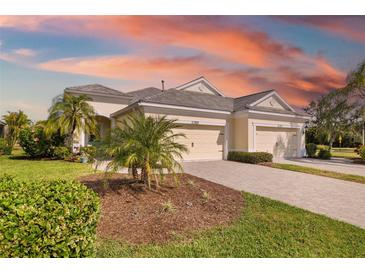 Charming single-story home boasts a well-manicured lawn, paver driveway, and a three-car garage at 12019 Sawgrass Lake Ter, Bradenton, FL 34211