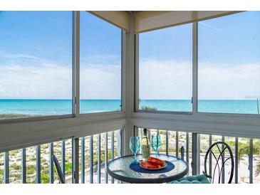 Stunning ocean view from the balcony with outdoor seating, featuring clear blue skies and refreshing sea breezes at 1255 Tarpon Center Dr # 315, Venice, FL 34285