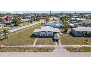 Charming single-story home with a well-manicured lawn, inviting curb appeal, and a classic driveway at 211 Dalton Blvd, Port Charlotte, FL 33952