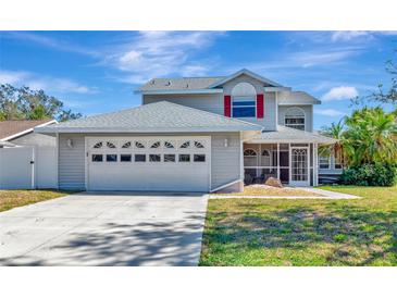 Charming two-story home featuring a two-car garage and a screened-in porch at 6145 Bonaventure Ct, Sarasota, FL 34243