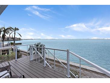 Enjoy serene water views from this coastal balcony with modern white railings and relaxing seating at 5279 Isla Key S Blvd # 113, St Petersburg, FL 33715