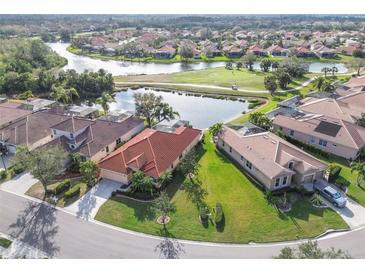 Beautiful aerial view of homes surrounding a scenic pond and golf course in a sunny community at 6512 Tailfeather Way, Bradenton, FL 34203