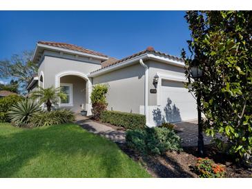 Charming single-story home with a well-manicured lawn and inviting front entrance at 7108 Playa Bella Dr, Bradenton, FL 34209