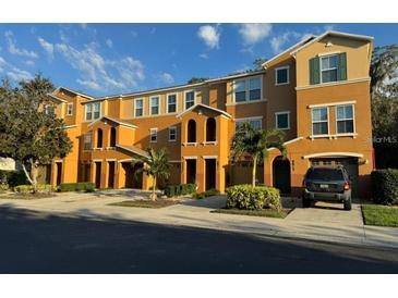 Townhouse with an attractive stucco facade, private parking, and well-maintained landscaping at 8811 White Sage Loop # 8811, Lakewood Ranch, FL 34202