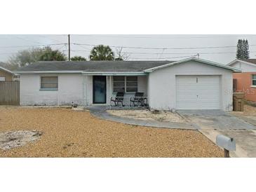 Quaint single-story home with an attached garage and a small front porch area at 3544 Brompton Dr, Holiday, FL 34691