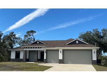 Newly constructed home with a two-car garage and modern design at 5221 San Mateo Dr, North Port, FL 34288