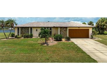 Single-story home with a brown garage door and well-manicured lawn at 2484 Broad Ranch Dr, Port Charlotte, FL 33948